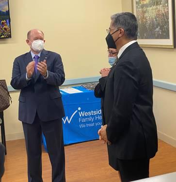 Men in suits talking to each otherDescription automatically generated with medium confidence