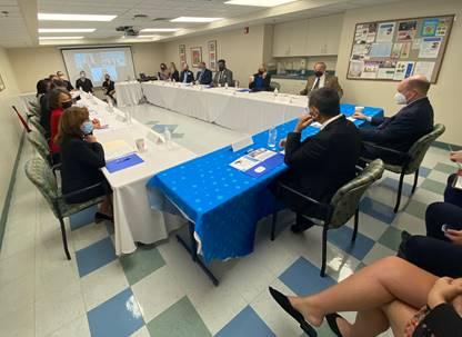 A group of people sitting around a tableDescription automatically generated with medium confidence