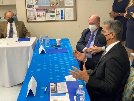 Men in suits sitting at a tableDescription automatically generated with low confidence