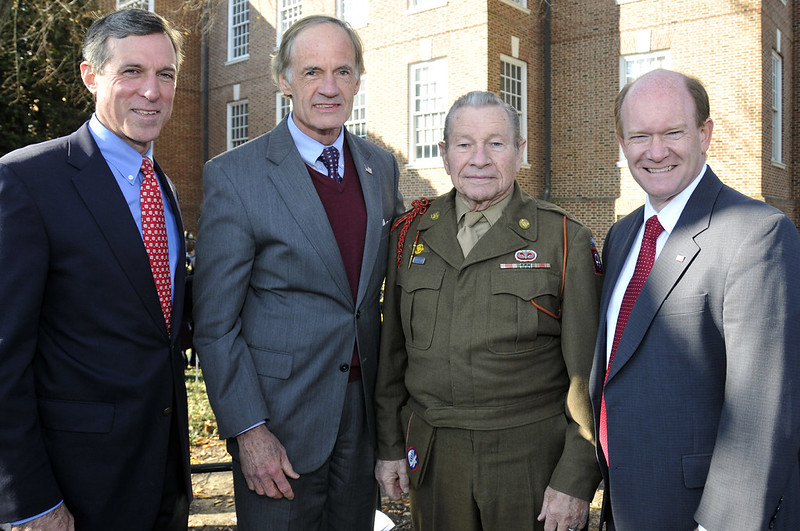 U.S. Rep. John Carney, Sen. Tom Carper, former State Rep. Jerry Unruh, and Sen. Chris Coons appear together after the dedication ceremony of a World War II memorial at Legislative Hall in Dover, Del., Nov. 9, 2013. Unruh is a former paratrooper and combat engineer who served with the 82nd Airborne Division during WWII.