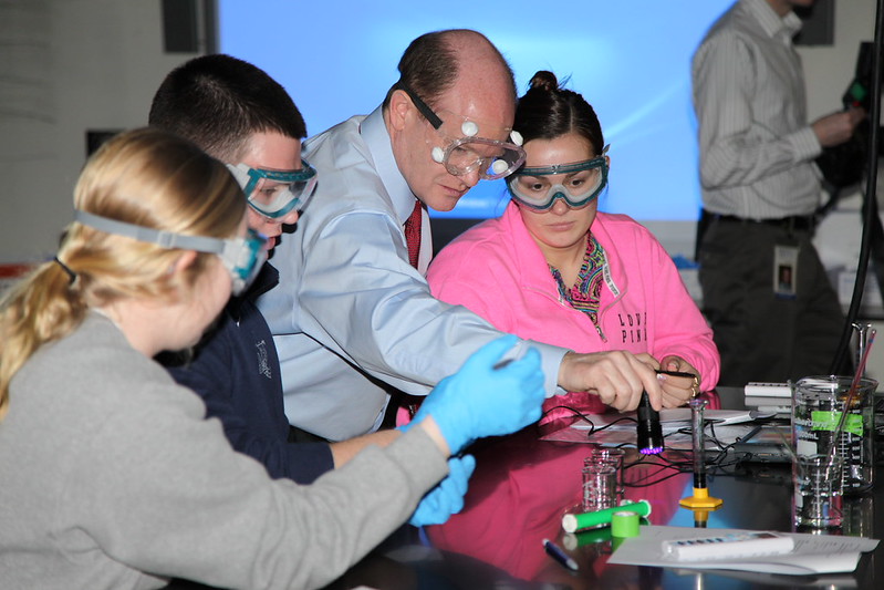 Senator Coons works with biochemistry students at UD on February 20, 2014