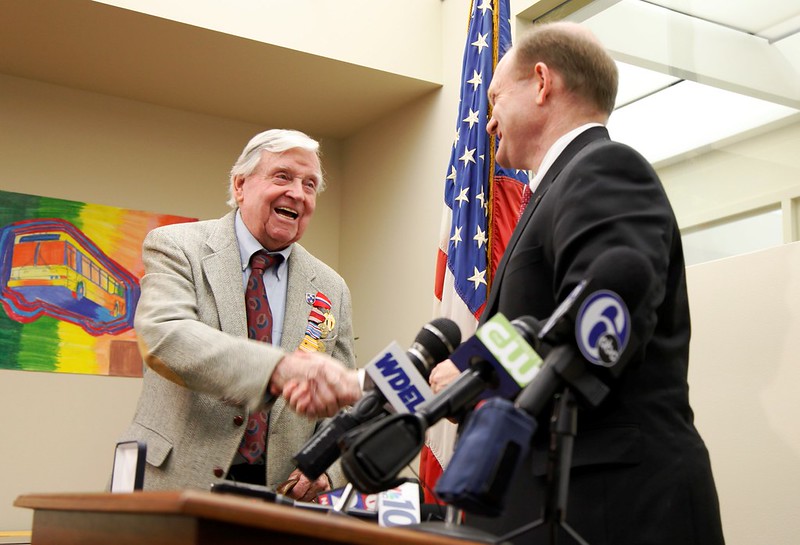 Senator Coons shakes hands with WWII veteran Francis 