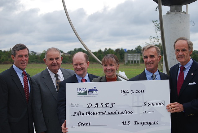 Senator Coons with the Congressional Delegation holding a grant check