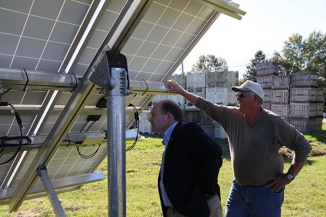 Senator Coons looking at solar panels on T.S. Smith & Sons farm.