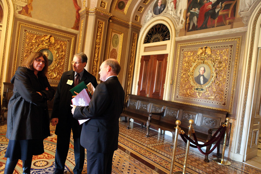 Senator Coons talks with an economist after a meeting on jobs in the Capitol