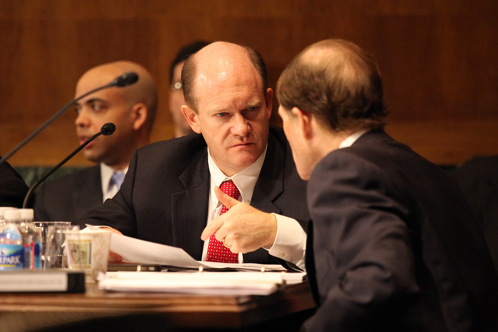 Senators Coons and Blumenthal confer during the VAWA markup