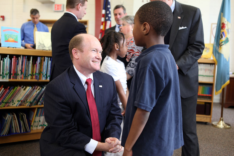 Photo of Senator Chris Coons with a young student