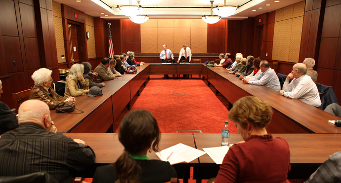 Photo of Senators Coons and Carper talking to the Delaware Farm Bureau